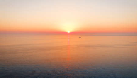 Endless tranquil seascape with sunset skyの写真素材