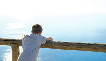boy looking at the sea.の写真素材