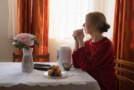 Beautiful young woman drinking tea at home