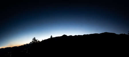 The silhouette of a mountain in the Swiss Alps, at nightの写真素材
