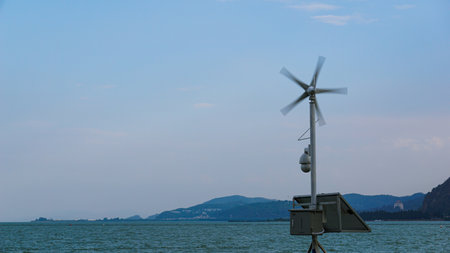 Windmill on a pier in Lake Garda, Lombardy, Italyの写真素材