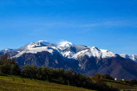 panorama of the majella mountain with snowy peak and wind that sweeps the snowの写真素材