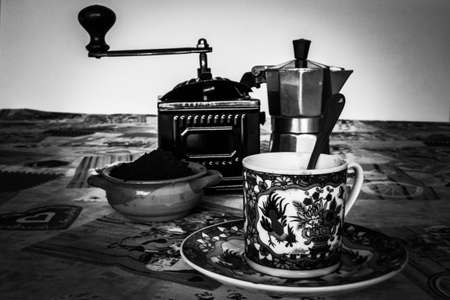 Black and white image of a coffee grinder and a cup of coffeeの写真素材