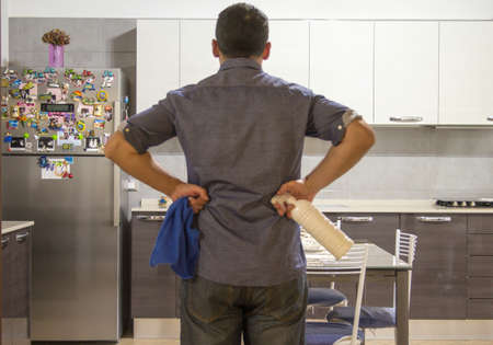 boy with spray cleaner and dish towel preparing to clean the house.の写真素材