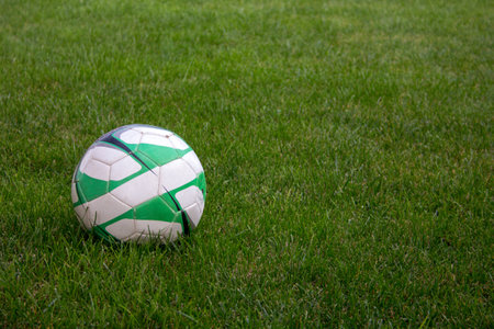 Image of a soccer ball in a green grass. outdoor games.の写真素材