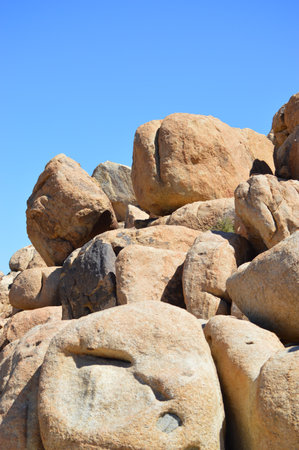 Rock formation in Joshua Tree, CA against blue skyの写真素材