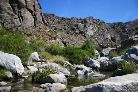 Mountain landscape with a river in the foreground and rocks in the backgroundの写真素材