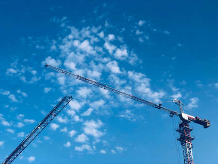 Construction site in Dnipro city. View Of two heavy industrial Cranes At Construction Site Against...