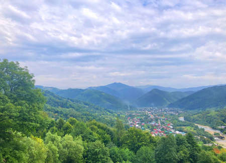Carpathians, Ukraine, Europe. View from the top of a mountain to the valley with the village. Summer...
