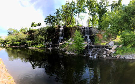 Sports tourism center in park of Far Eastern Federal University FEFU, located on Russky Island. Park with lake, waterfalls and forest near embankment. Tourists are engaged in outdoor activities.の写真素材
