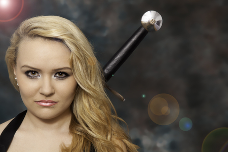 Attractive blond woman with swordの写真素材
