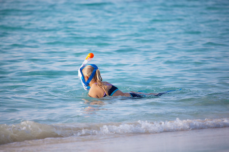 A young woman go snorkeling in the oceanの写真素材