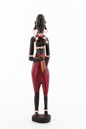 A wooden figure of a Maasai women on white backgroundの写真素材