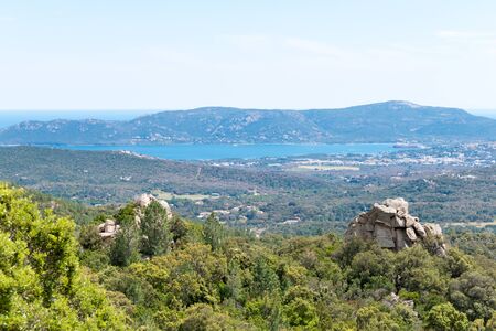 A landscape shot with green forests, mountains and a blue skyの写真素材
