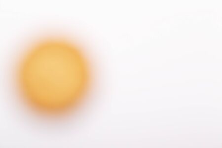 A Yellow blurred circle on a white background