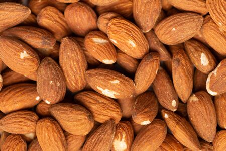 A lot of beautiful almond nuts as a backgroundの写真素材
