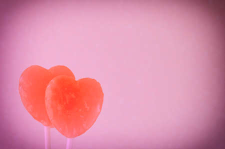 Red hearts on pink background textureの写真素材