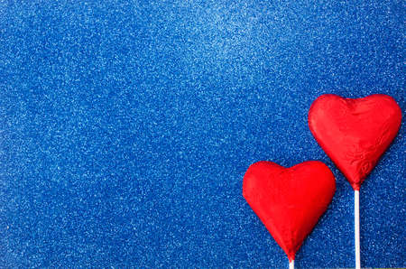 Red hearts on blue background textureの写真素材
