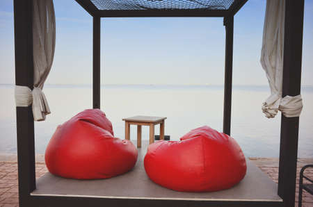 Morning at the sea view with red a seatの写真素材