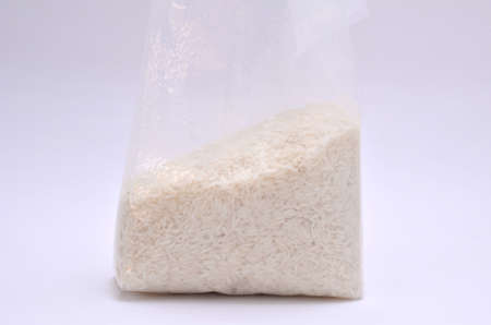 Jasmine rice in plastic bag on white backgroundの写真素材
