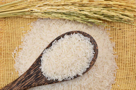 Jasmine rice on wood spoon and strawの写真素材