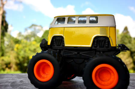 Yellow toy car on a wooden floor and view forestのeditorial素材