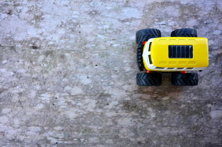 Yellow toy car on a wooden floorのeditorial素材