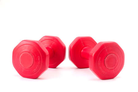Red dumbbells on white background