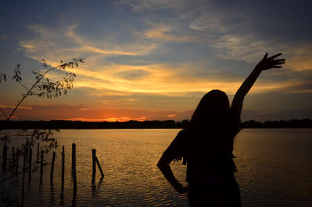 Women relax near river with sunsetの写真素材