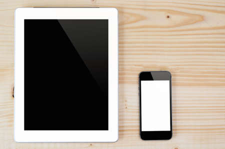 Top view taplet and smart phone on wood background