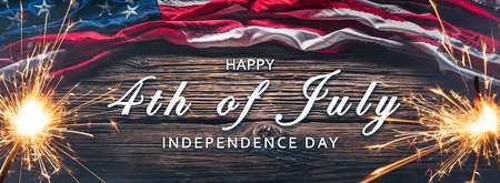 American Flag With Sparklers And Smoke On Wooden Background With Words Happy 4th of July...