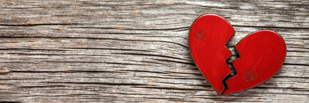 Broken heart on rustic wooden background. Valentines day conceptの写真素材