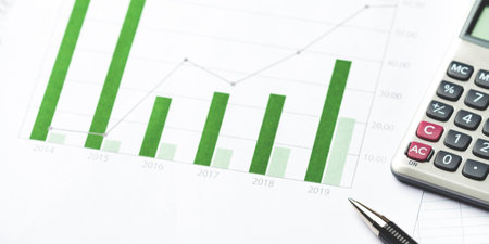 Graphs and Charts of financial report with calculator and pen.の写真素材