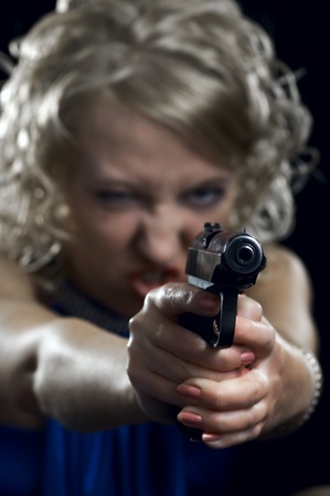 woman with weapon on black backgroundの写真素材