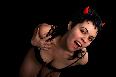 portrait of the passionate woman with tattoo on black background