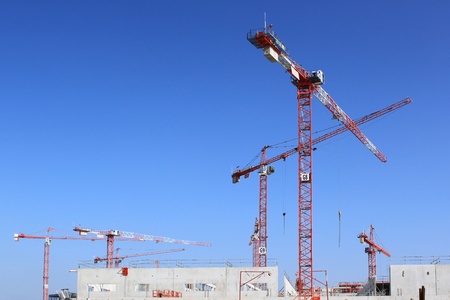 for several cranes on a building construction site for building or public worksの写真素材