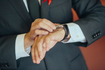 Businessman checking the time on his wrist watchの写真素材