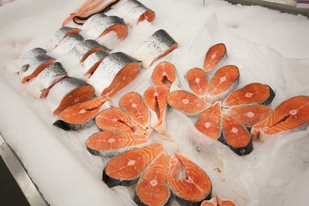 frozen red fish steaks on the ice in the marketの写真素材