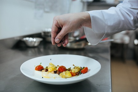 Chef preparing food in the kitchen on panの写真素材