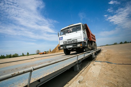 Omsk, Russia - June 2: truck Kamaz drive on the road construction on June 2th 2015 in Omskのeditorial素材