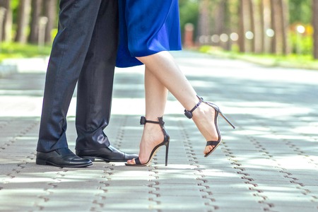 Male and female legs during a date in the parkの写真素材