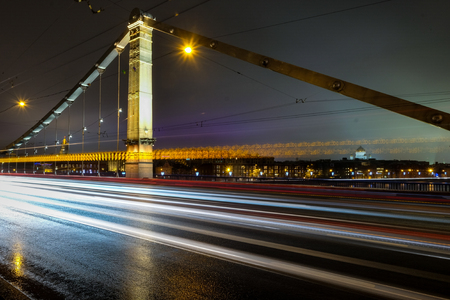 Light trails on the bridge at night with yellow lights and cleanest sky as backgroundの写真素材