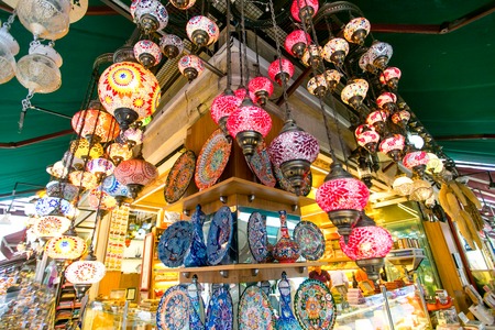 Colorful glass mosaic lamps and decorative plates at a lampshopの写真素材