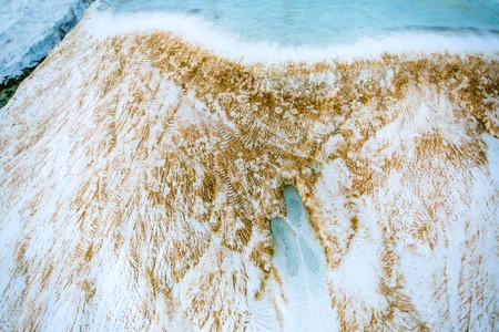 White mineral texturized travetine surface close-up with blue poured water - Pamukkale, Turkeyの写真素材