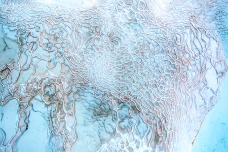 close-up view of white patterned travertine part with amazing texture and blue and light outlines - Pamukkale, Turkeyの写真素材