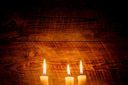 Background with candles light on wood in darkの写真素材