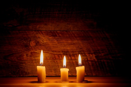 Background with candle light on wooden board at the night with beautiful reflectionの写真素材