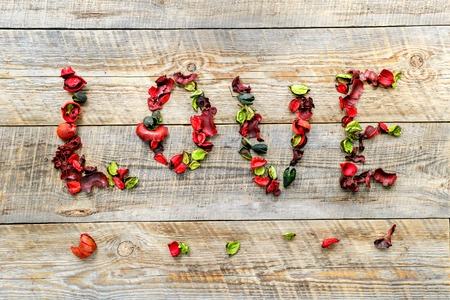 Word Love background scene - petals on wooden boardの写真素材