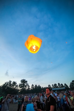 Omsk, Russia - June 16, 2012: festival of Chinese paper lantern, the crowd starts them in the skyのeditorial素材