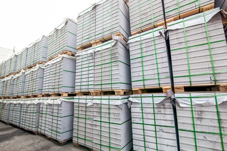 Stack of aerated concrete blocks - slabs near a house-building factory workshop outdoor